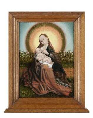 Maria met kind in een stralenkrans voor een rozenhaag